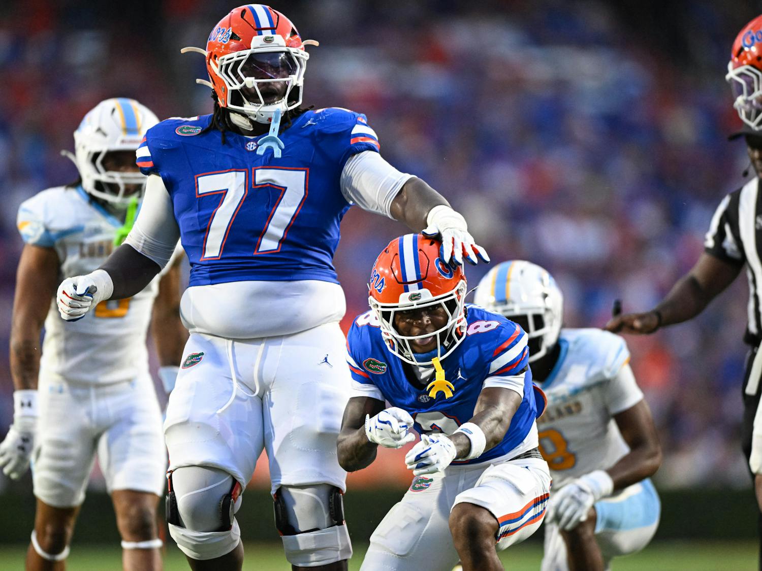 Florida Gators wide receiver Vernell Brown III (8) and offensive lineman Knijeah Harris (77) celebrate a play during a football game between the Long Island Sharks and the Florida Gators on Saturday, Aug. 30, 2025, at Ben Hill Griffin Stadium in Gainesville, Fla.