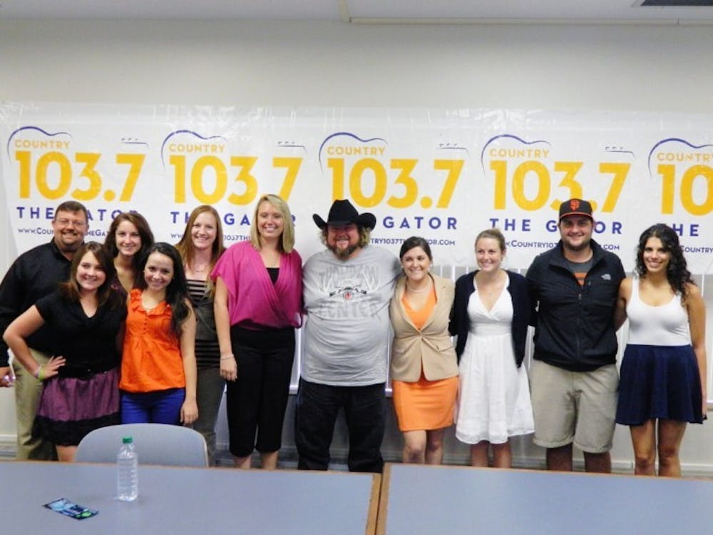 <p>Telecommunication students and faculty pose with country-rapper Colt Ford after a question and answer session at Weimer Hall Thursday.</p>