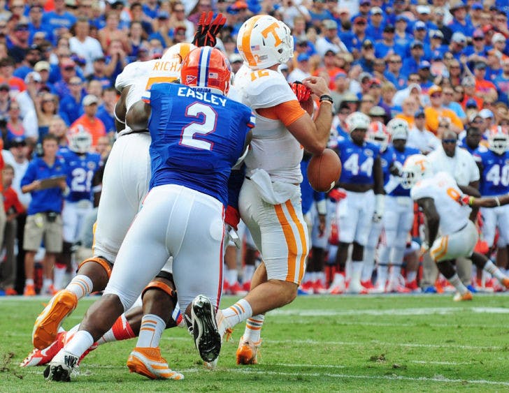 Dominique Easley forces a fumble during Florida’s 31-17 victory against Tennessee on Saturday in Ben Hill Griffin Stadium. Easley is out for the season after suffering tears to the ACL and meniscus in his right knee.