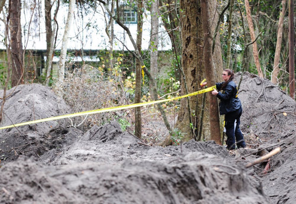 <p class="p1">An ASO Forensics Unit investigator tapes off a dig site Thursday where a team searched for the remains of Tiffany Sessions, who went missing 25 years ago in Gainesville.</p>