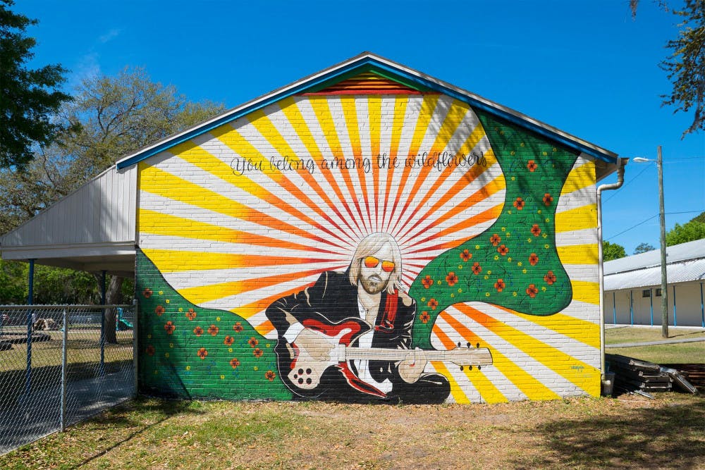 The owners of Visionary CrossFit, Carrie Martinez and Jesus Martinez, painted a Tom Petty tribute mural as a gift to Sidney Lanier Center.