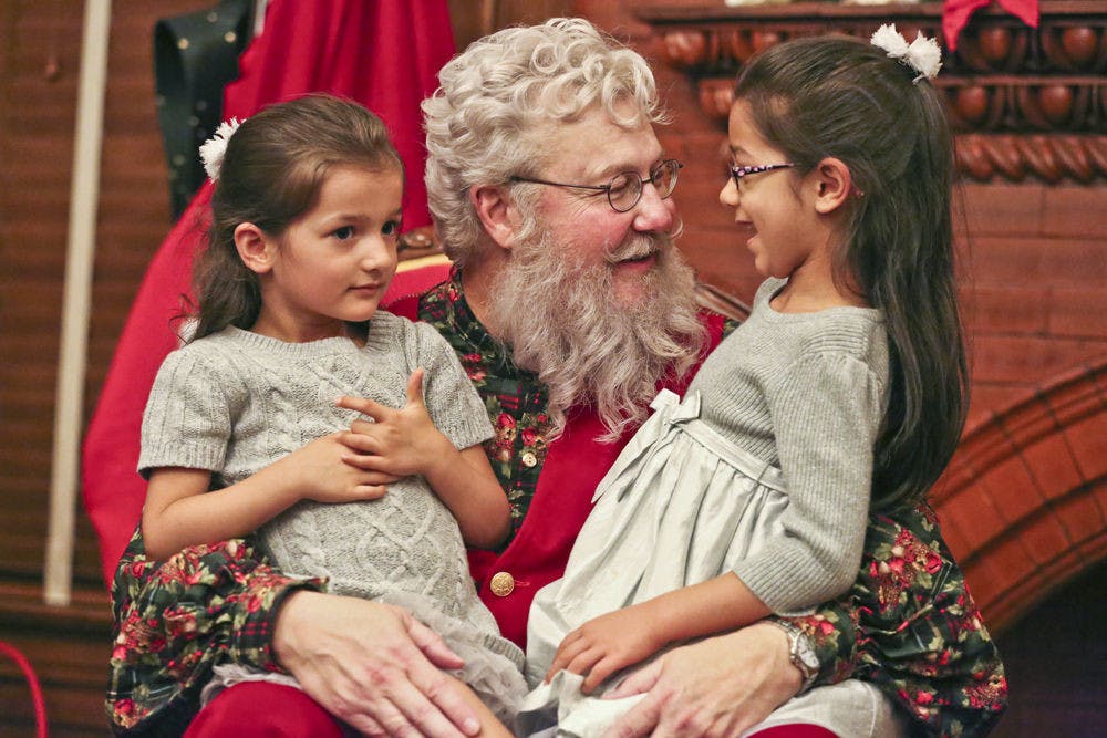Four-year-old Olivia Wood, left, and 6-year-old Isabel Wood tell Santa about their Christmas wishes during the annual Holiday Tree Lighting ceremony on Saturday. “They’re always super excited for Christmas,” said Ligia Wood, a web designer and the girls’ mother.