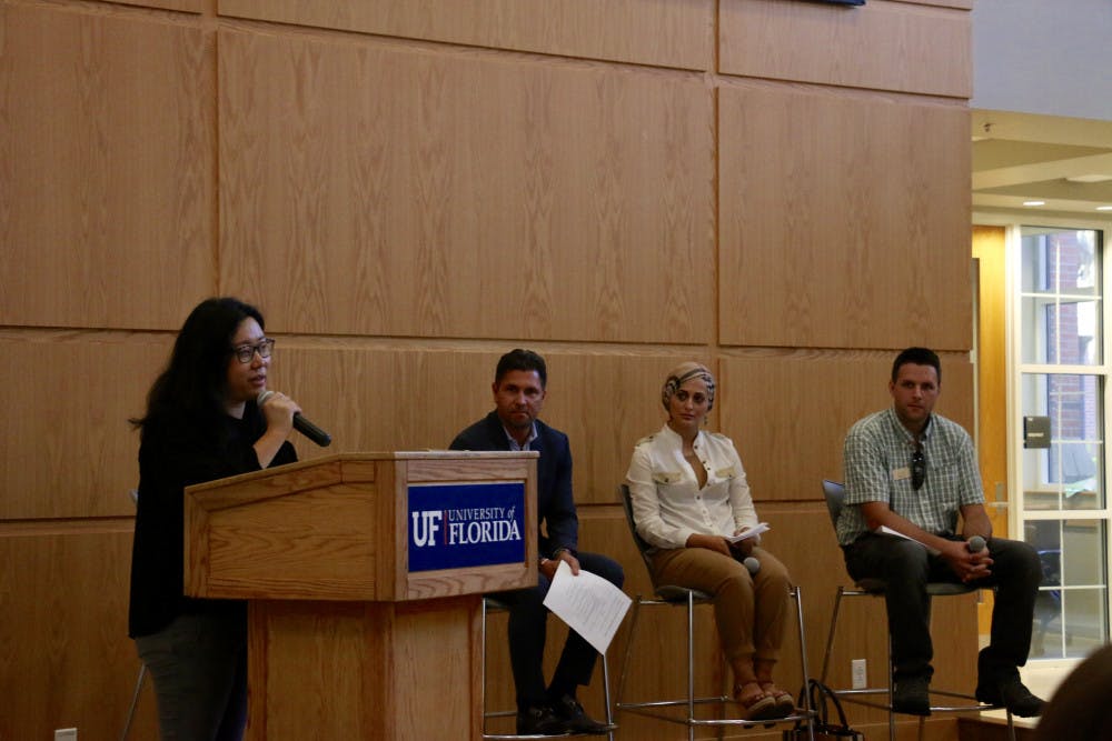 Seyeon Hwang, a 31-year-old UF urban and regional planning doctorate student, opens the event “Home Away from Home: Remembering Refugees in Florida” on Thursday night in Pugh Hall by introducing the panelists before the discussion portion. Hwang, who came to America as a refugee herself, is involved extensively in both local and national refugee advocacy programs.