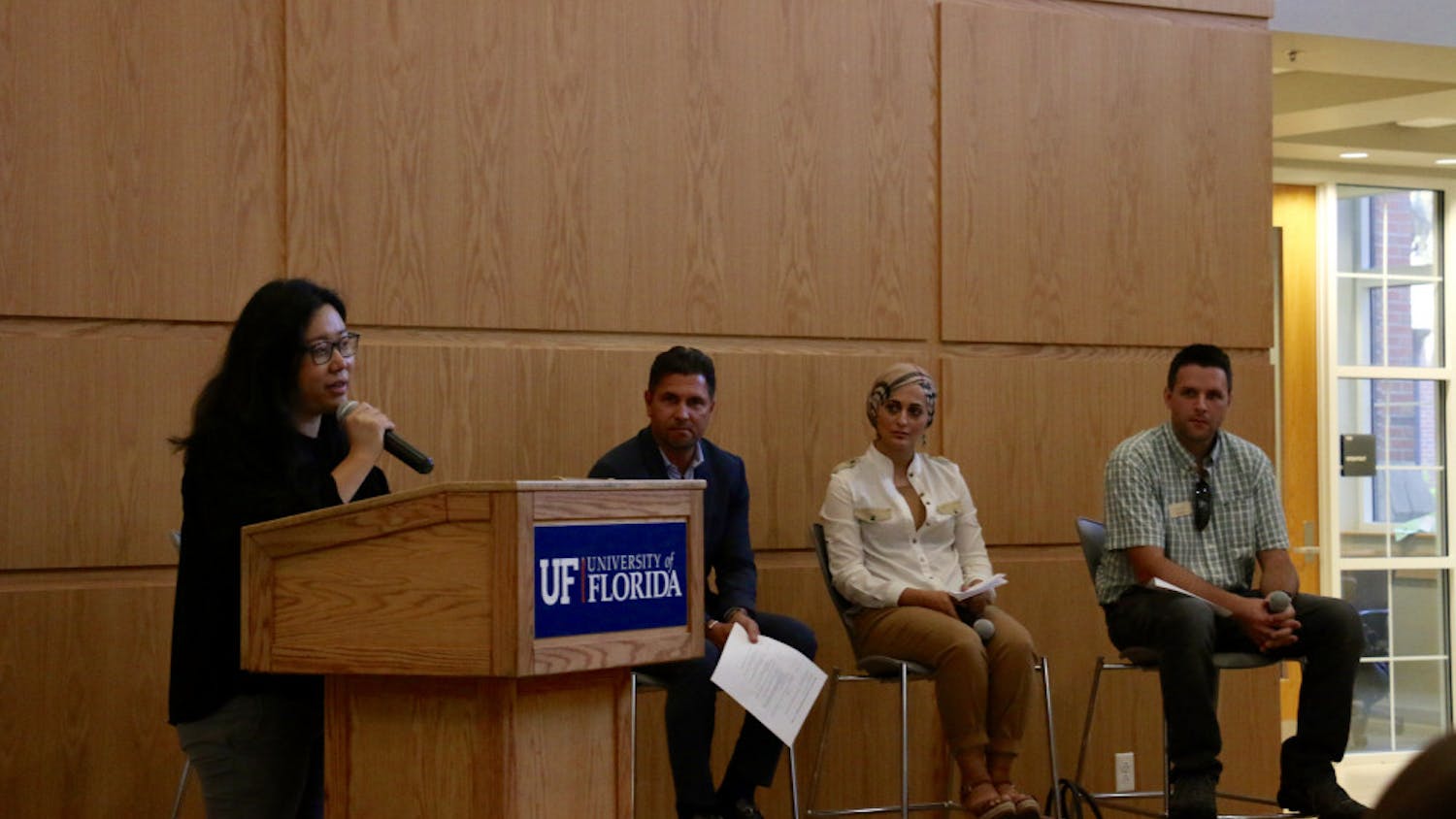 Seyeon Hwang, a 31-year-old UF urban and regional planning doctorate student, opens the event “Home Away from Home: Remembering Refugees in Florida” on Thursday night in Pugh Hall by introducing the panelists before the discussion portion. Hwang, who came to America as a refugee herself, is involved extensively in both local and national refugee advocacy programs.