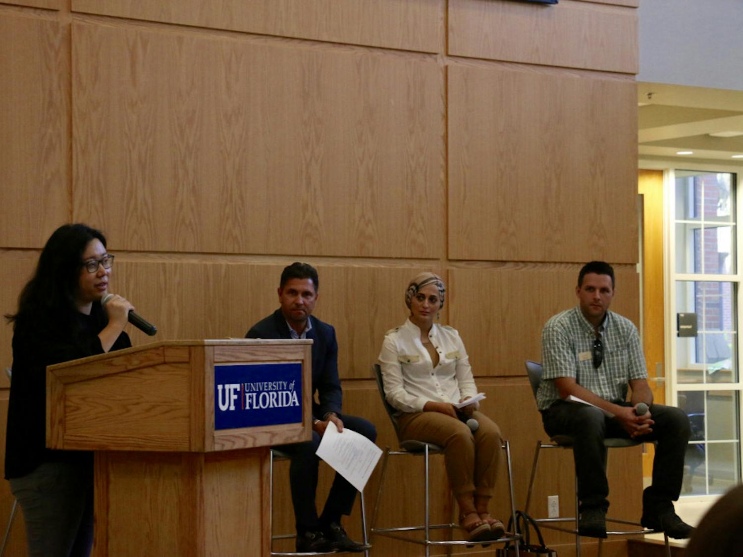 Seyeon Hwang, a 31-year-old UF urban and regional planning doctorate student, opens the event “Home Away from Home: Remembering Refugees in Florida” on Thursday night in Pugh Hall by introducing the panelists before the discussion portion. Hwang, who came to America as a refugee herself, is involved extensively in both local and national refugee advocacy programs.