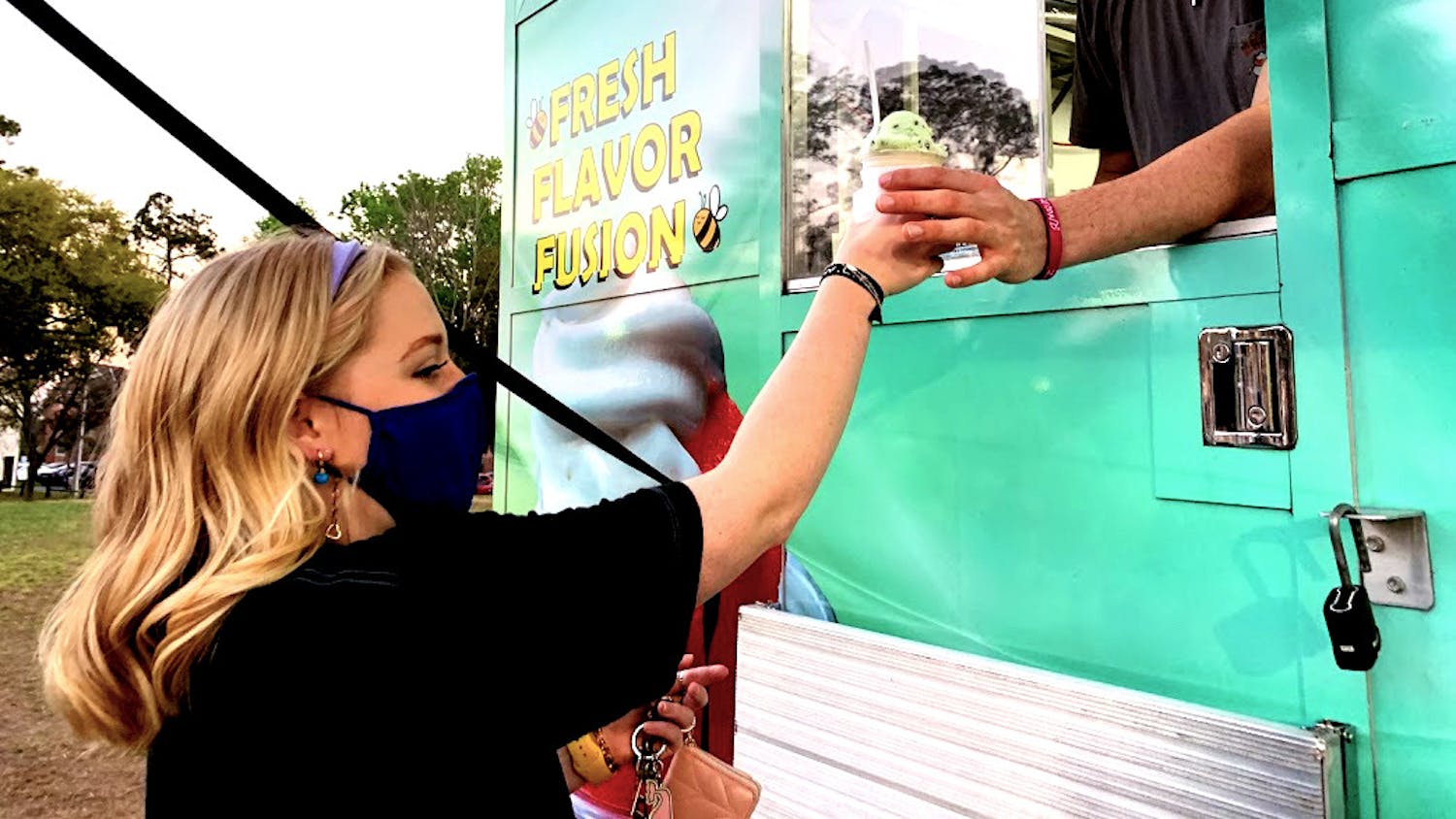 Zoe Strahan, a sophomore at the University of Florida, gets her long-awaited gelati from B’z Gelati food truck at the Bonnamu Music Festival on March 12, 2021. Strahan said that if the gelati truck made more than $300 that evening, then the proceeds will go to the Children’s Miracle Network Hospitals. 