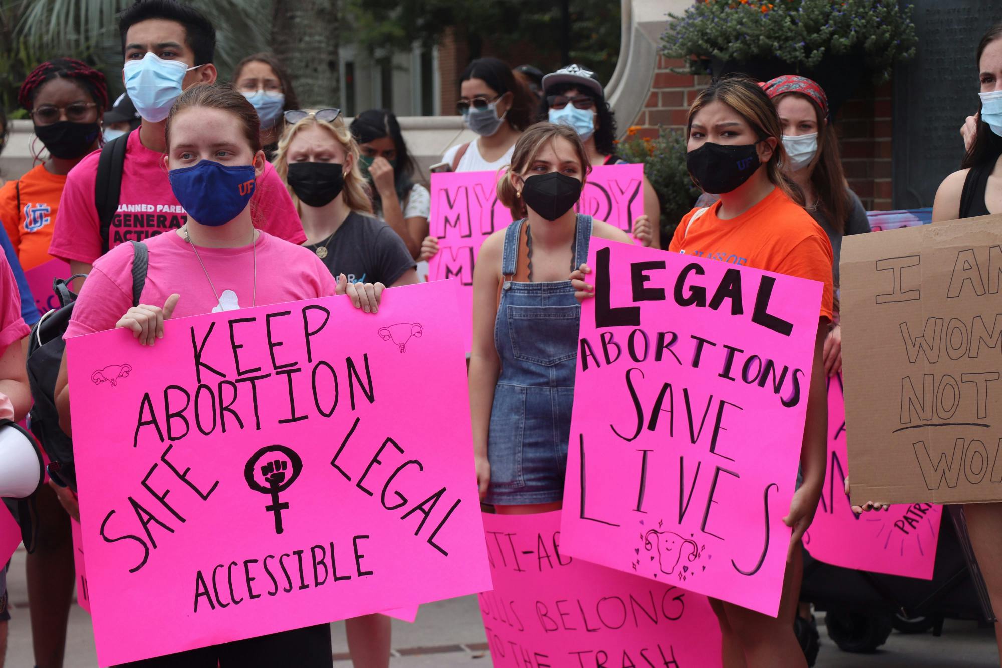 Protestors gather at the corner of West University Avenue and Southwest 13th Street before marching to Cora P. Roberson Park on Saturday, Oct. 2, 2021.