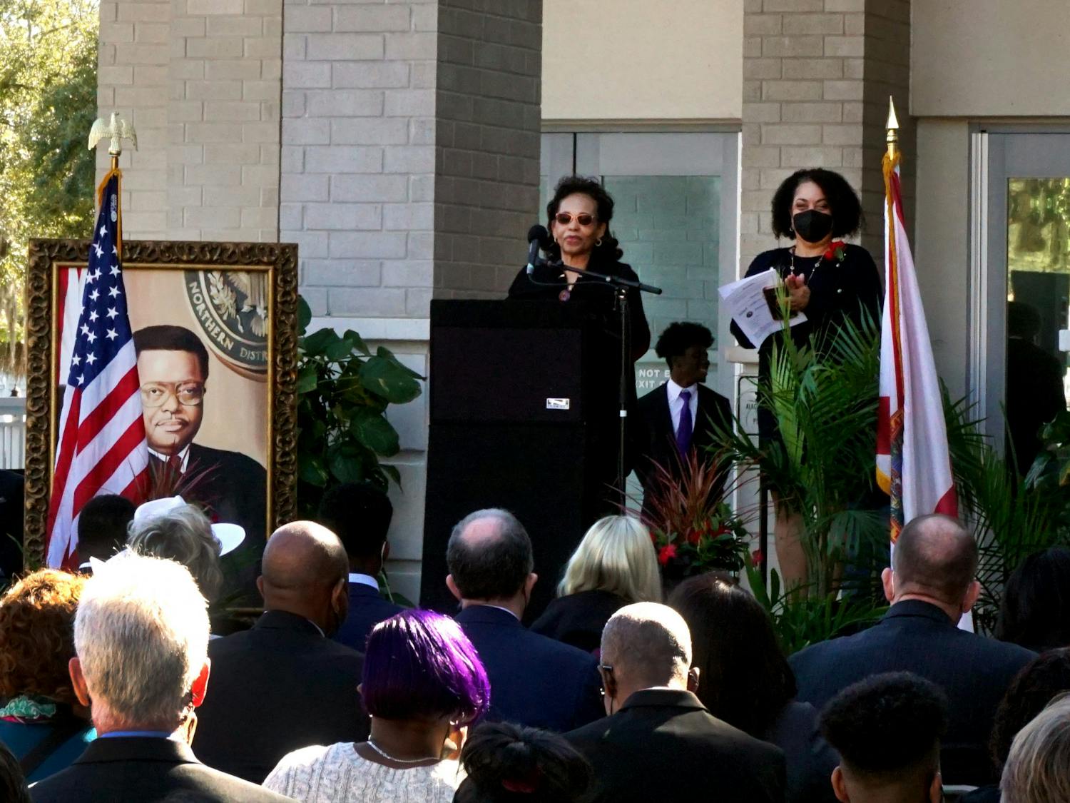 Judge Stephan Mickle's wife, Evelyn Mickle, speaks at the podium about her husband's trailblazing legacy at the renaming ceremony of the Alachua County Courthouse on Friday, Jan. 14. The courthouse is located at 220 S. Main St.