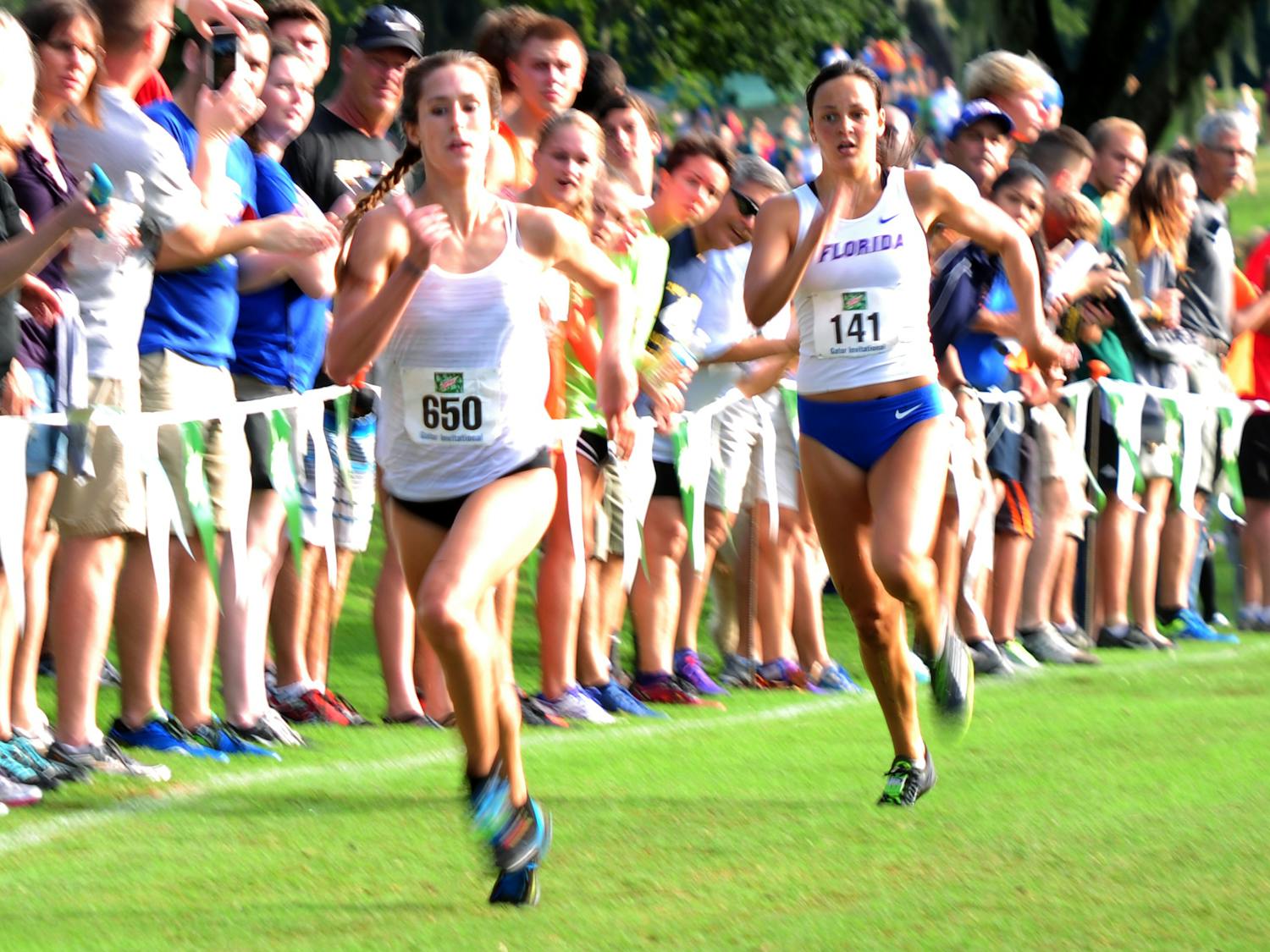 UF's Becky Greene (right) races to the finish during the Mountain Dew Invitational on Sept. 19, 2015, at the Mark Bostick Golf Course.
