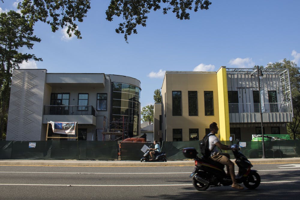 Students pass in front of the location of the newly renovated IBC and La Casita buildings.
