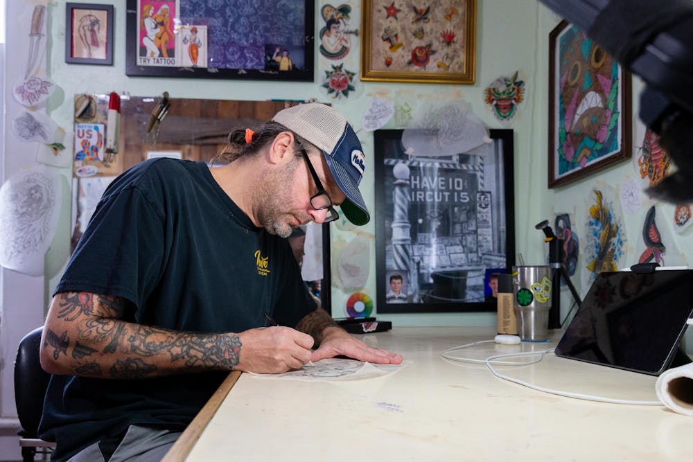 <p>Tattoo artist Mike Salay sketches a new design on Wednesday, Sept. 11, 2024.</p>