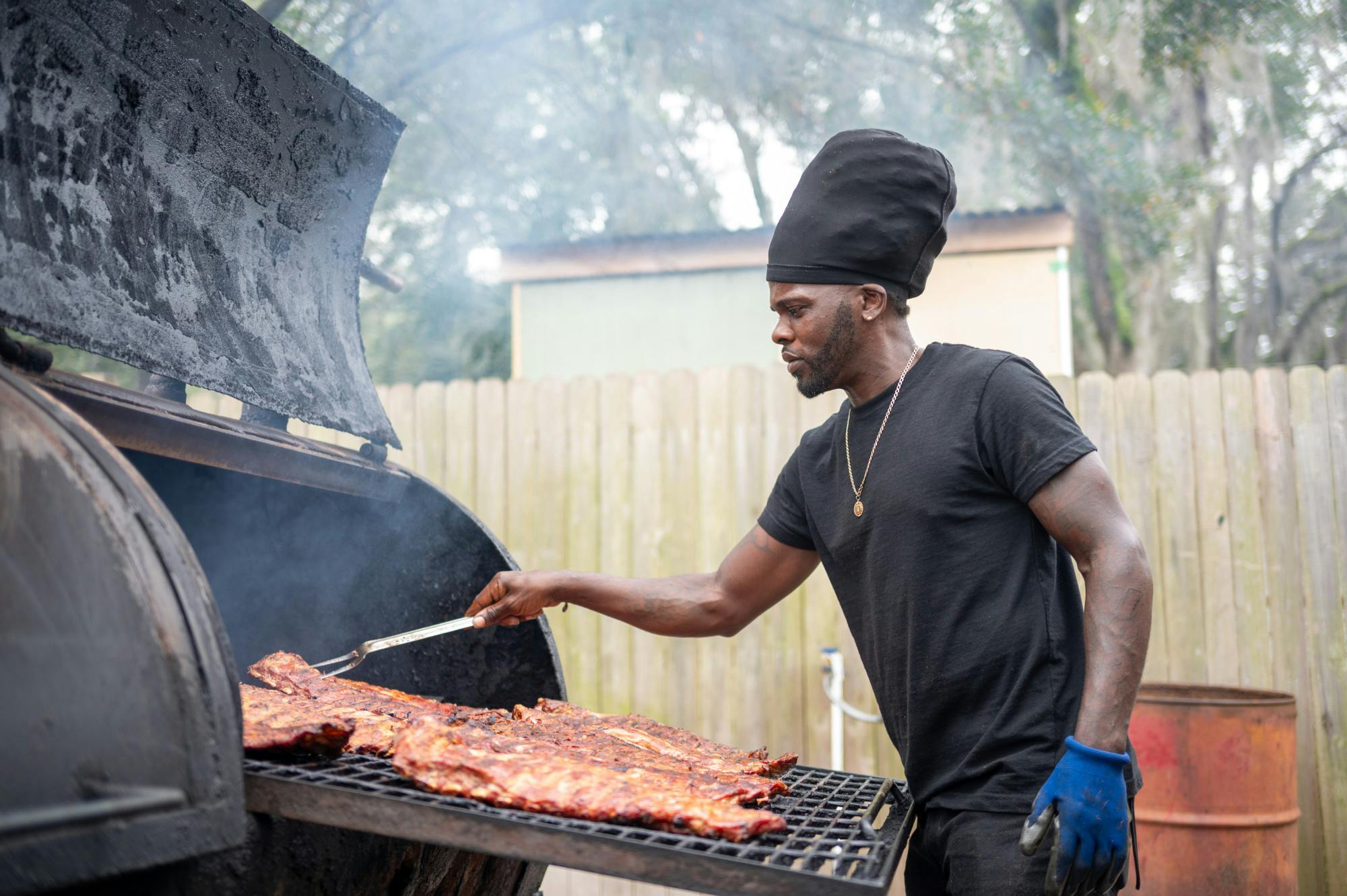 Damien Filmore of Terrell&#x27;s Barbecue cooks ribs on the grill in Gainesville, Fla., on Friday, Feb. 14, 2025.