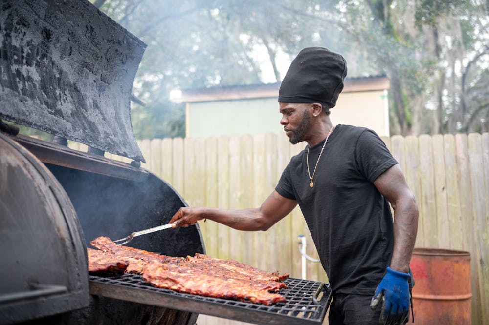 <p>Damien Filmore of Terrell&#x27;s Barbecue cooks ribs on the grill in Gainesville, Fla., on Friday, Feb. 14, 2025.</p>