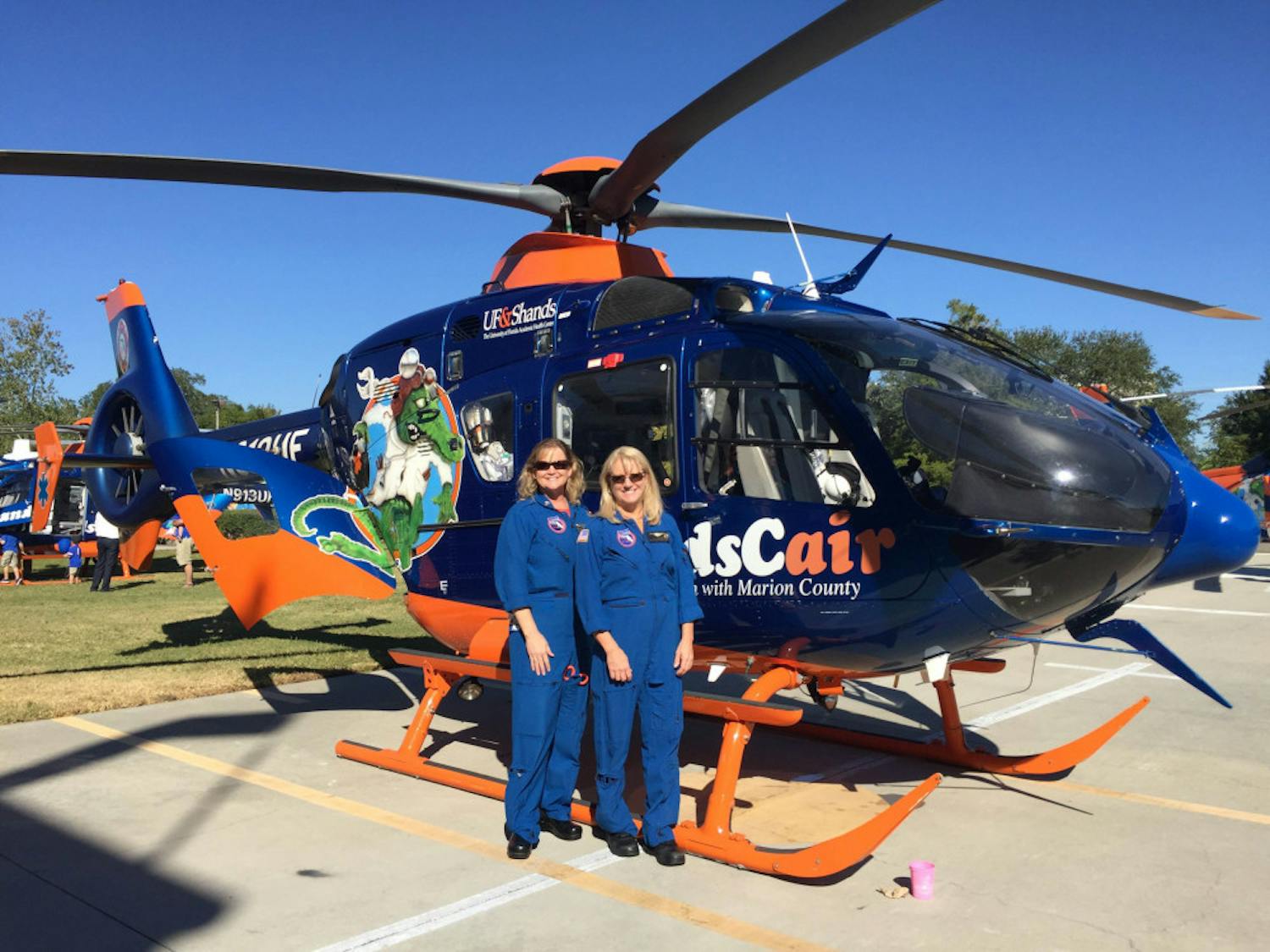 ShandsCair 2, an EC13-model helicopter, sits in the sun during the 35th anniversary celebration of UF Health’s ShandsCair on Saturday. It is just one of three helicopters used to transport patients from the scene to the UF Health Shands Hospital, a level-one trauma center.