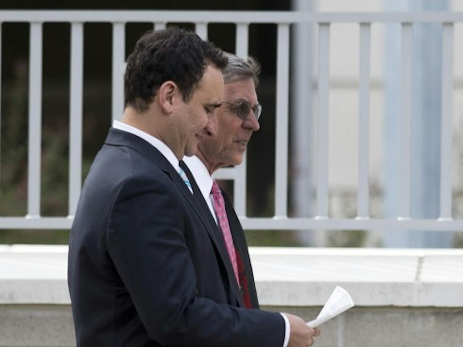 Luis Pereira walks out of the Alachua County Criminal Justice Center with his attorney, Huntley Johnson, Oct. 25. Gainesville Police arrested Pereira on charges of sexual battery twice in three years. In both cases, he plead no contest to other charges.