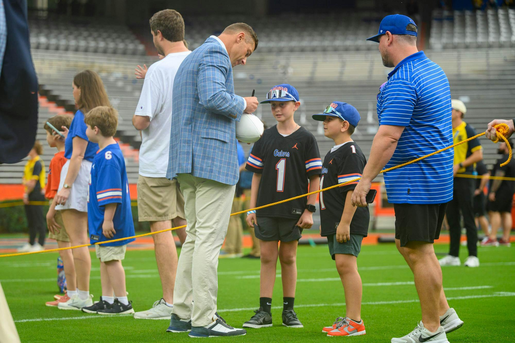Florida head coach Jon Sumrall signs a football before an NCAA college football game against South Carolina, Saturday, Oct. 10, 2026, in Gainesville, Fla.