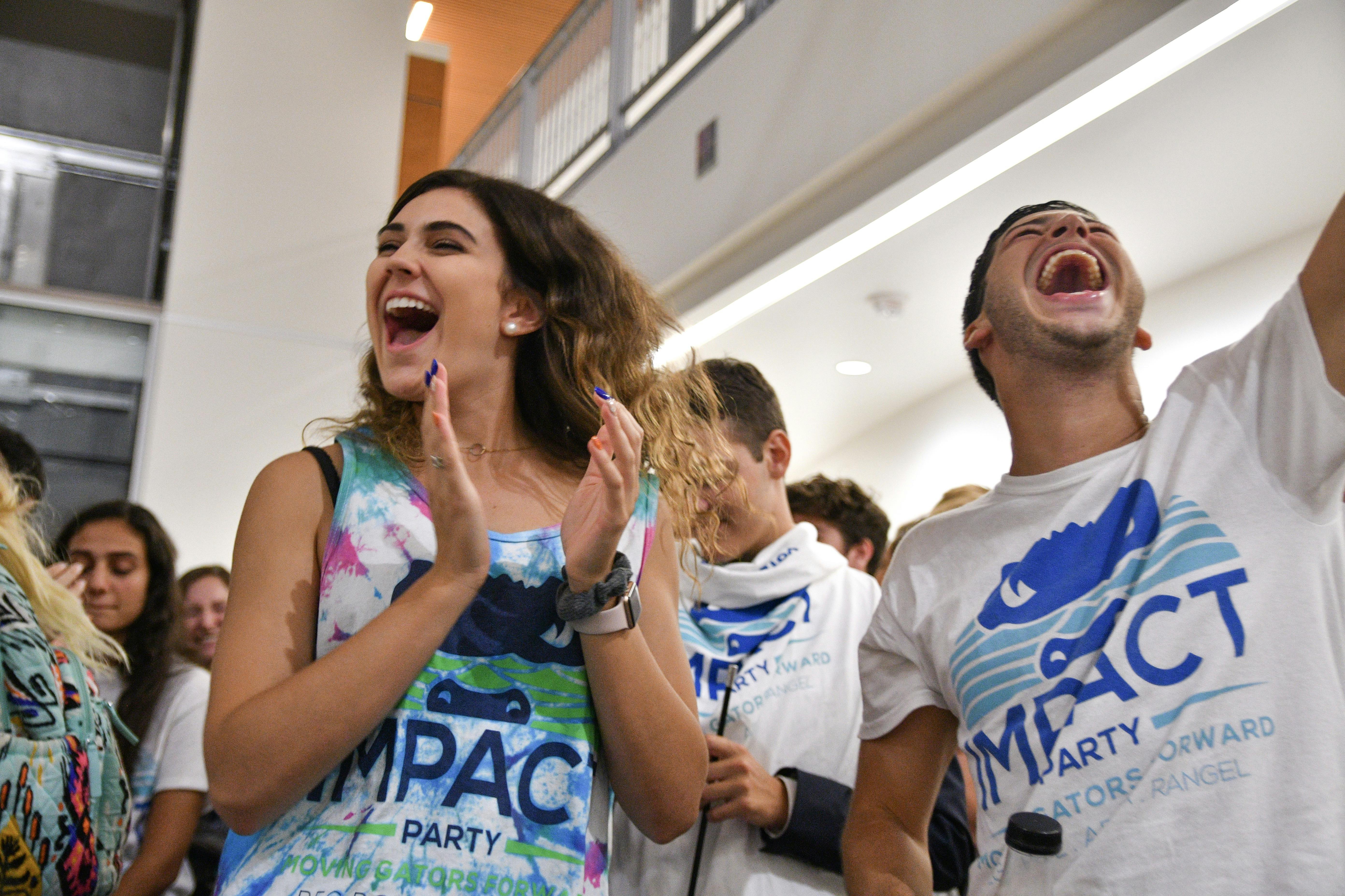 Lexie Atlas, a 19-year-old UF sophomore engineering student, celebrates with her friend Kyle Levy, who just won a District B Senator seat for the Impact Party. The results were read in the Reitz Union Wednesday night where Impact won 35 of 50 seats.  
