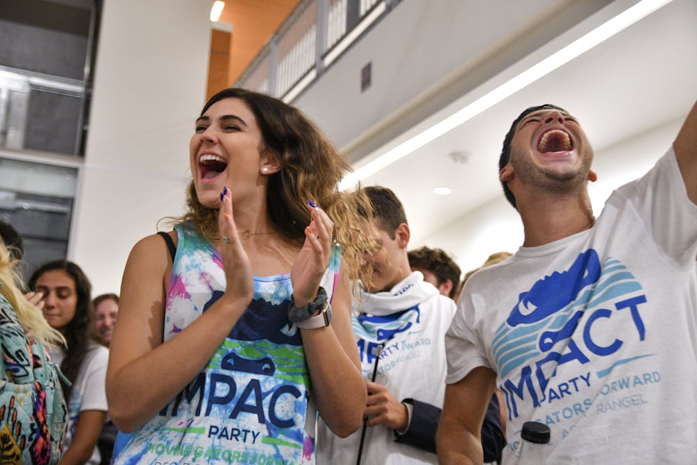 <p><span>Lexie Atlas, a 19-year-old UF sophomore engineering student, celebrates with her friend Kyle Levy, who just won a District B Senator seat for the Impact Party. The results were read in the Reitz Union Wednesday night where Impact won 35 of 50 seats. </span></p><p><span> </span></p>