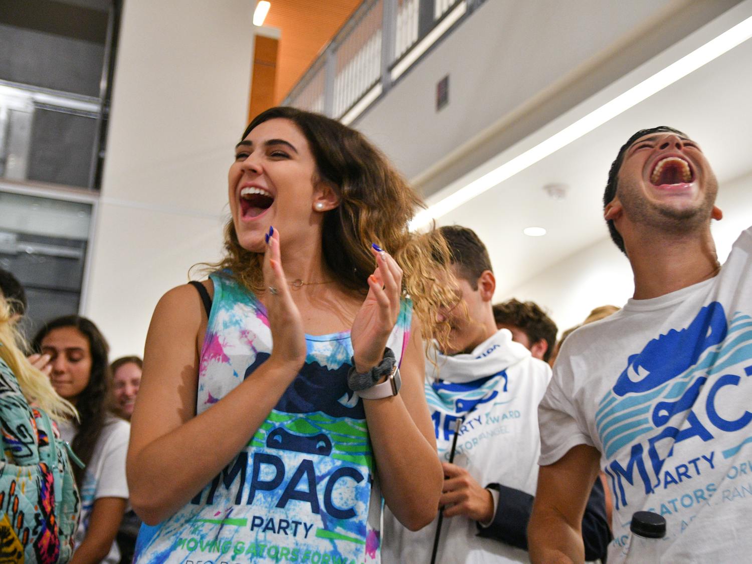 Lexie Atlas, a 19-year-old UF sophomore engineering student, celebrates with her friend Kyle Levy, who just won a District B Senator seat for the Impact Party. The results were read in the Reitz Union Wednesday night where Impact won 35 of 50 seats.