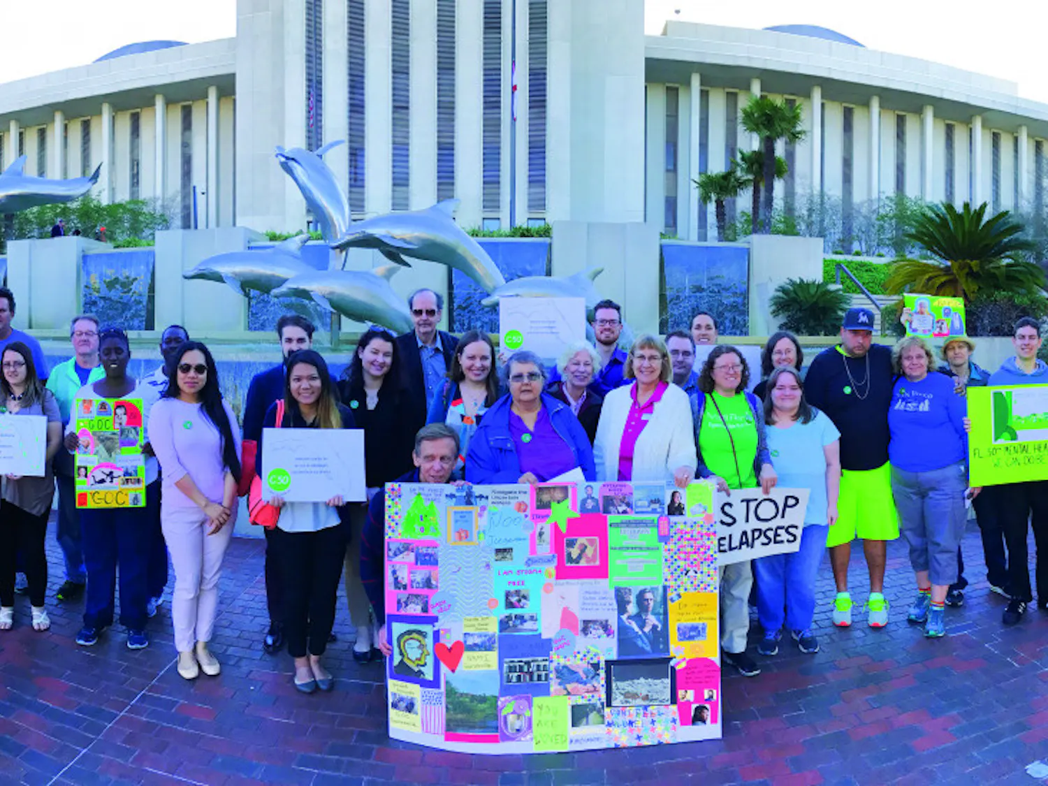 About 60 people pose for a photo in Tallahassee on Thursday. The group traveled to the state capitol to lobby for better mental health services in Florida.