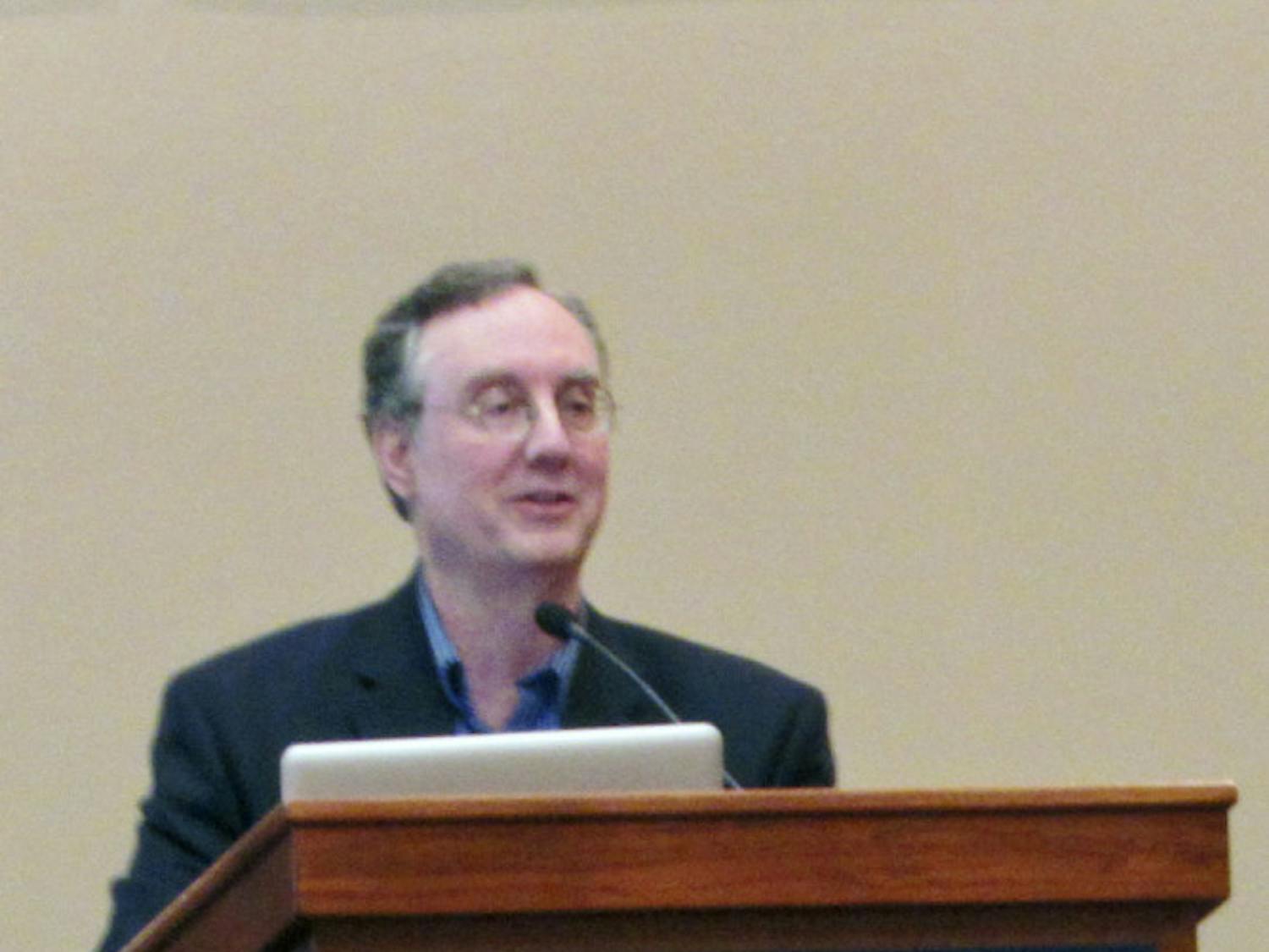 Dr. Juan Cole, a professor of history from the University of Michigan, speaks to an audience on youth involvement in Middle Eastern politics in the Reitz Union Grand Ballroom on Thursday night.
