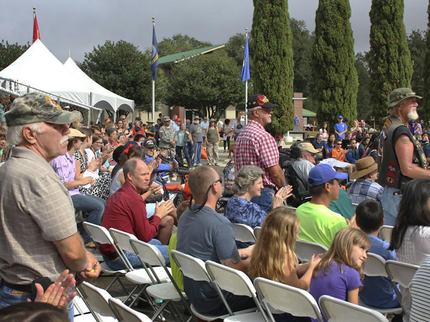 Vietnam War veterans stand up to be recognized at Kanapaha Veterans Memorial Park on Nov. 11, 2015. The speaker who asked them to stand said they worked just as hard as veterans in any other war.