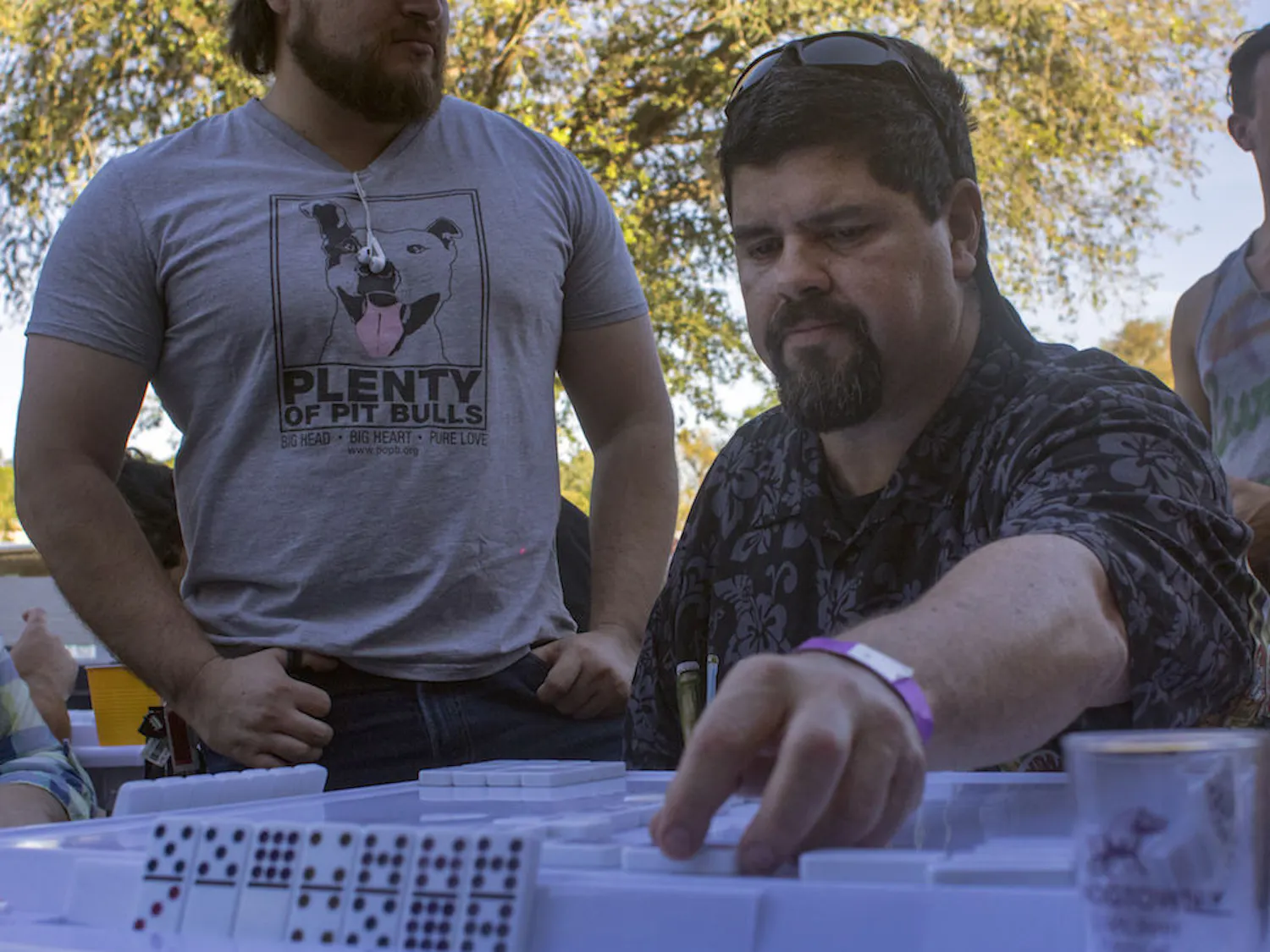 Juan Martinez, a 49-year-old Gainesville resident, plays dominoes Saturday during the Mi Apa Domino Tournament and Elio Piedra Conga Drum Ensemble at Mi Apa Latin Cafe, 114 SW 34th St. More than 50 people participated in this event.