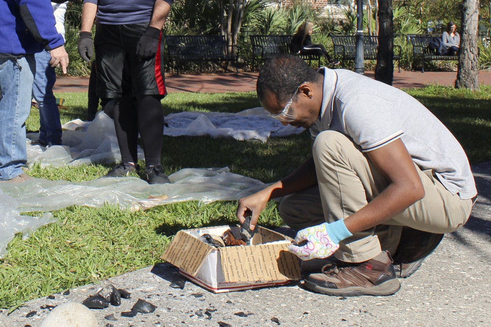 Abebe Taffere, a 35-year-old UF first-year archaeology graduate student, sifts through a box of stones, which he used to construct a tool. Taffere is a member of “UF and Ethiopia,” a course that is sending 10 students to an archaeological excavation in Ethiopia.