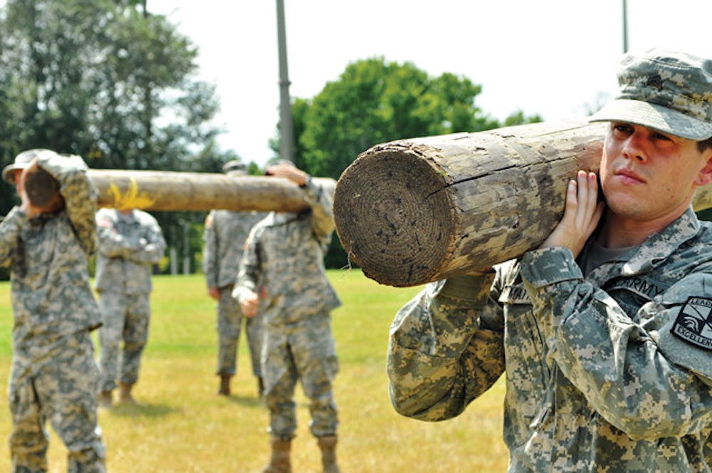<p>Cadet Sgt. Ben Mathews, a family, youth and community sciences major, lifts a log in a drill&nbsp; to prepare for Ranger Challenge.</p>