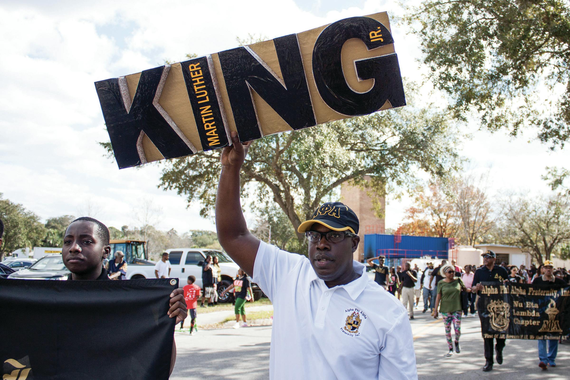 Maurice Spence, the president of the Alpha Phi Alpha fraternity Gainesville chapter, holds a Martin Luther King Jr. sign during a march on Monday. “We are instrumental as leaders for the civil rights movement,” Spence said about the fraternity. “We support Dr. King’s efforts on a local and national level.”