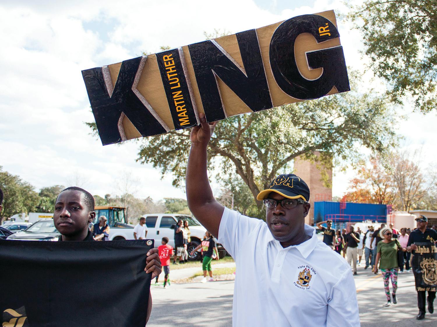 Maurice Spence, the president of the Alpha Phi Alpha fraternity Gainesville chapter, holds a Martin Luther King Jr. sign during a march on Monday. “We are instrumental as leaders for the civil rights movement,” Spence said about the fraternity. “We support Dr. King’s efforts on a local and national level.”