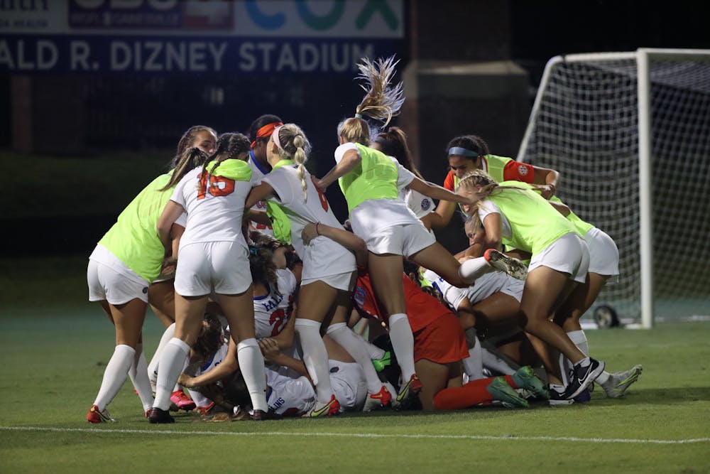 <p>Florida soccer jumps on Julianne Leskauskas in celebration of its win over Kentucky Sept. 23, 2021. The Gators announced the hiring of new head coach Samantha Bohon Monday.</p>