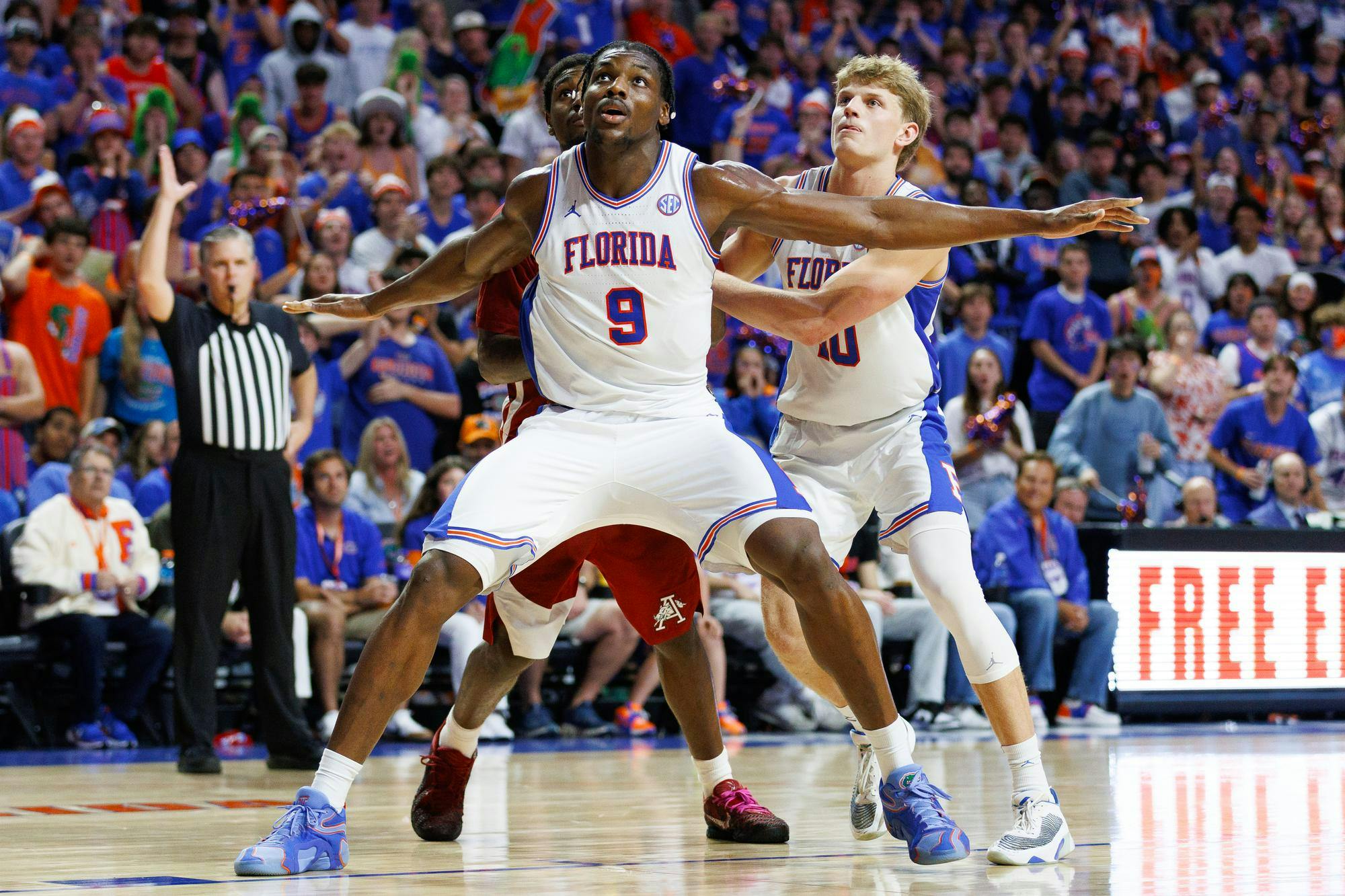 Florida center Rueben Chinyelu (9) boxes out against Arkansas wing Billy Richmond III (24) during the second half of an NCAA basketball game against Arkansas, Saturday, Feb. 28, 2026, in Gainesville, Fla.