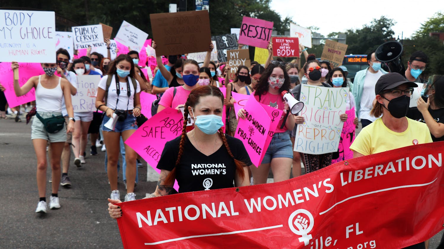 Abortion-rights protestors cross Southwest 13th Street at the North Central Florida March for Reproductive Rights & Justice on Saturday, Oct. 2, 2021. The group of over 100 marched to Cora P. Roberson Park to hear from a range of speakers including politicians and community activists.