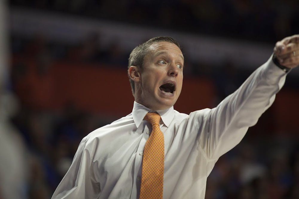 <p>UF coach Mike White points during Florida's 81-66 win over South Carolina on Feb. 21, 2017, in the O'Connell Center.&nbsp;</p>
