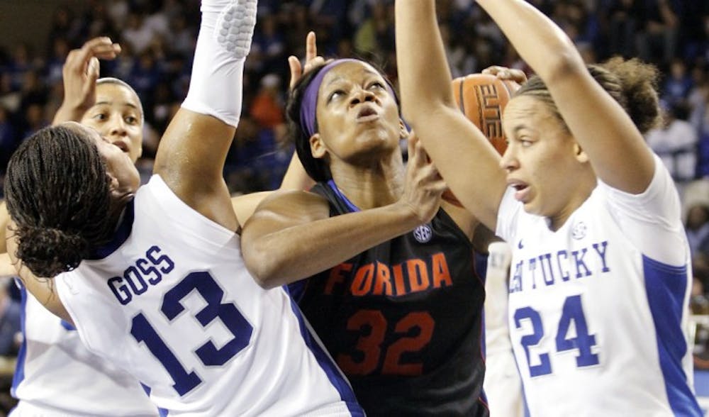 <p>Forward Jennifer George (32) battles in the paint with Kentucky guards Amber Smith (24) and Bria Goss during the Gators 57-52 loss to the Wildcats in Lexington, Ky., on Sunday. Florida has lost three straight to Kentucky.</p>