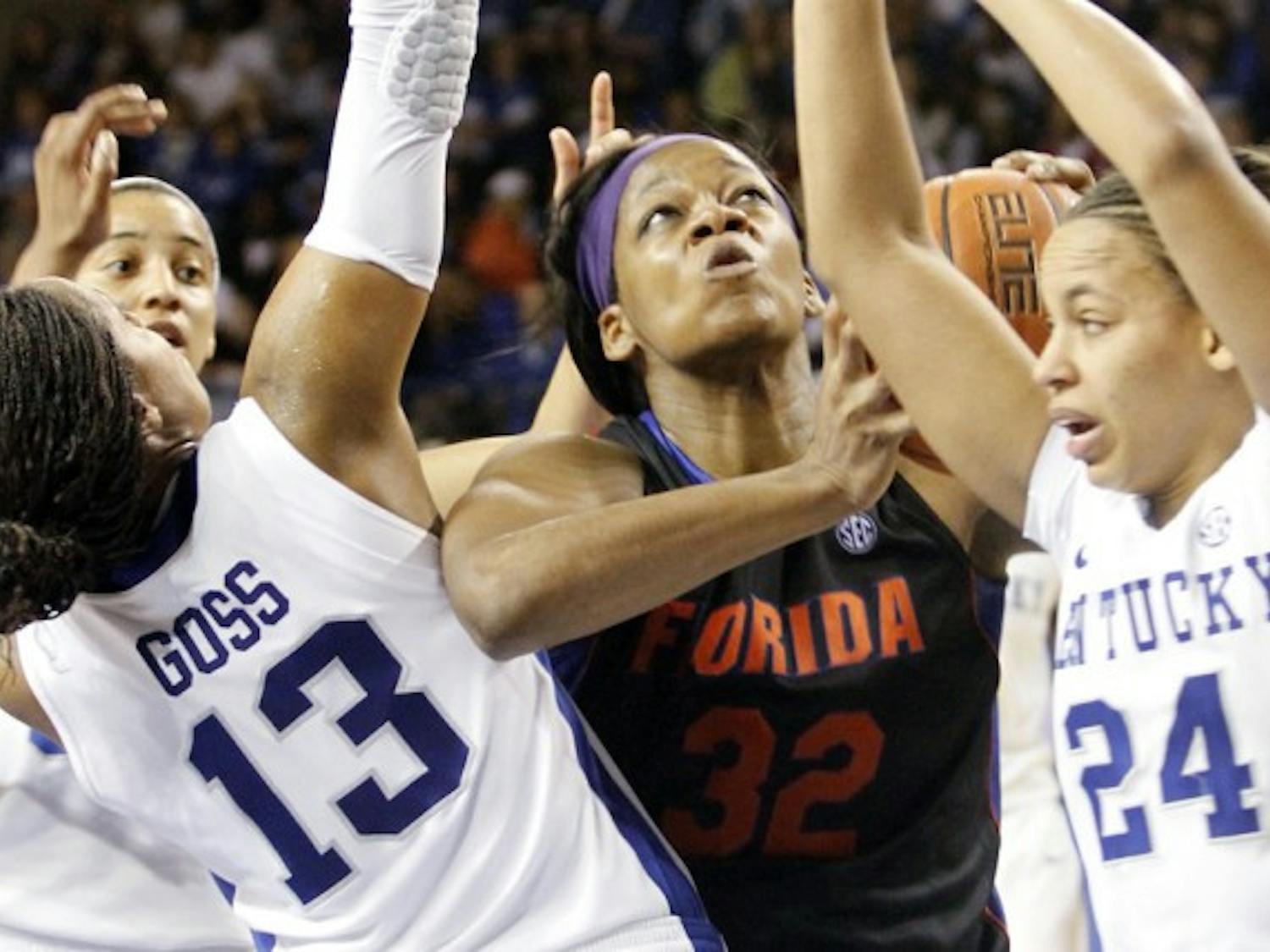 Forward Jennifer George (32) battles in the paint with Kentucky guards Amber Smith (24) and Bria Goss during the Gators 57-52 loss to the Wildcats in Lexington, Ky., on Sunday. Florida has lost three straight to Kentucky.
