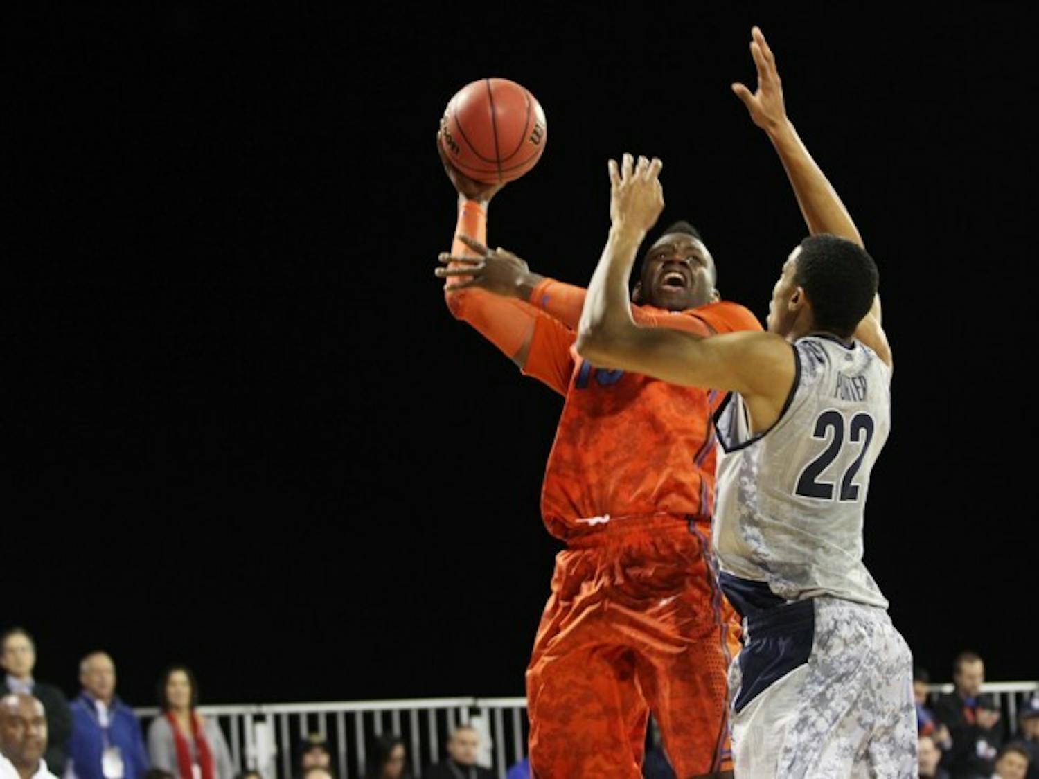 Florida forward Will Yeguete attempts a shot against Georgetown forward Otto Porter (22) aboard the USS Bataan in Jacksonville on Nov. 9.