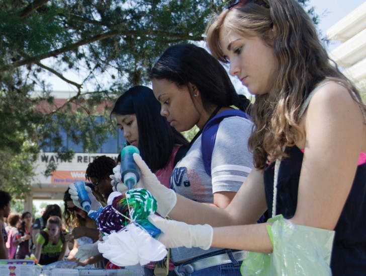 Tie-Dye RUB Down - Tori Selby, an 18-year-old history freshman, and other students tie-dye shirts on the Reitz Union North Lawn on Friday afternoon. The event was sponsored by RUB, and lasted from 11 a.m. until 3 p.m.