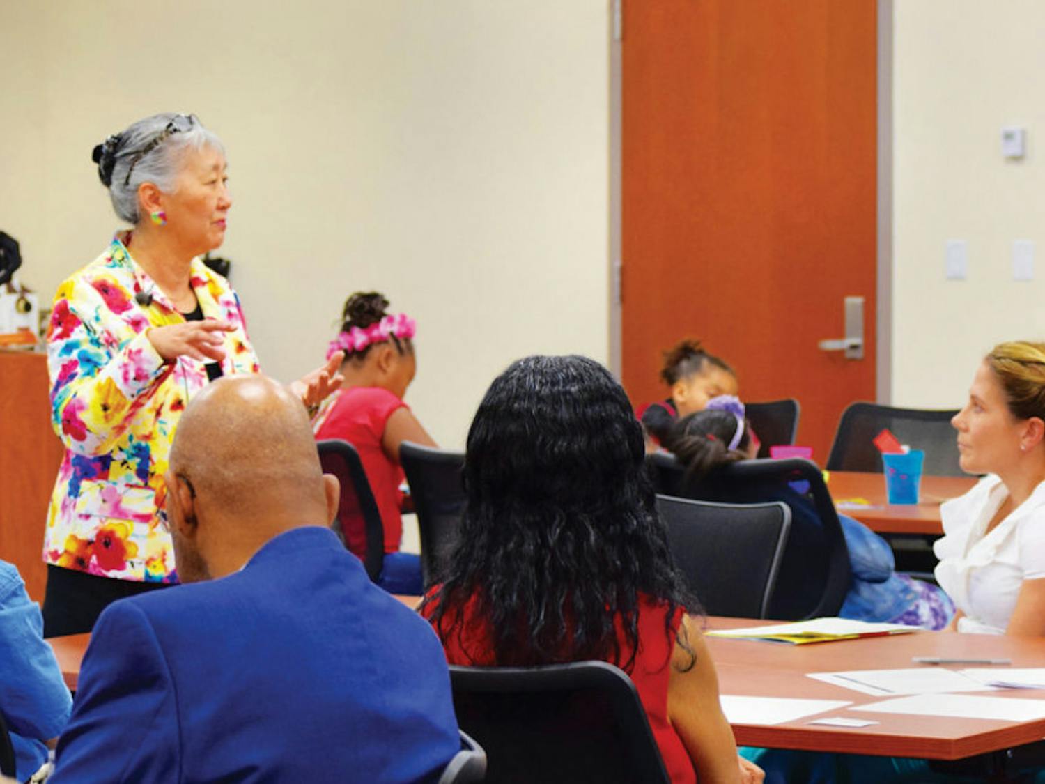 Eunshil McKenna, a licensed dietician and food and nutrition supervisor of Alachua County Public Schools, provides free nutrition advice to parents and families at the Nutrition Education Family Event at the Straughn Center on Saturday.