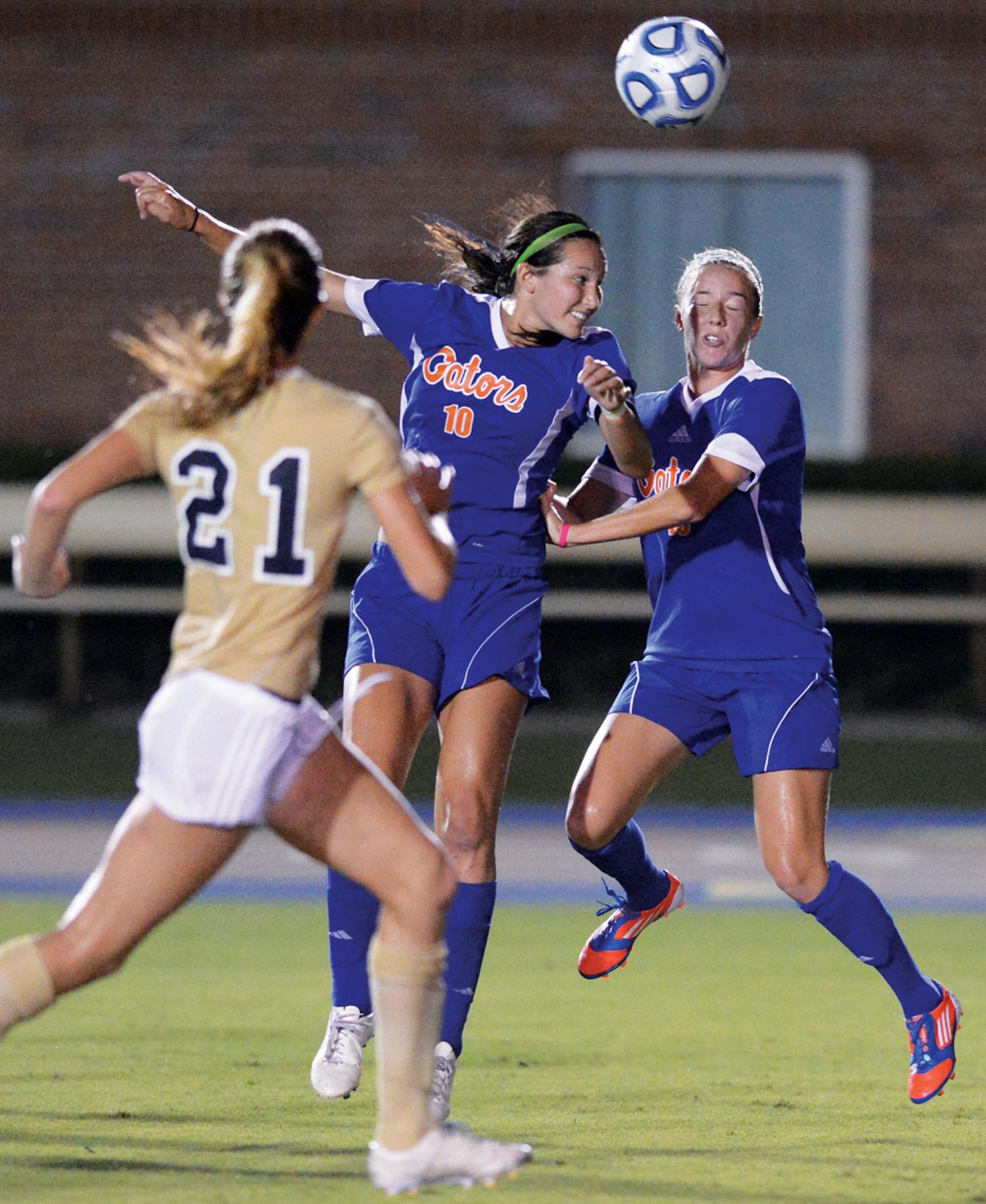 Midfielder Holly King (10) heads a ball during UF's 3-0 victory against Florida International University on Sept. 2. King works as an elementary school teacher at Levy County elementary school every Wednesday.