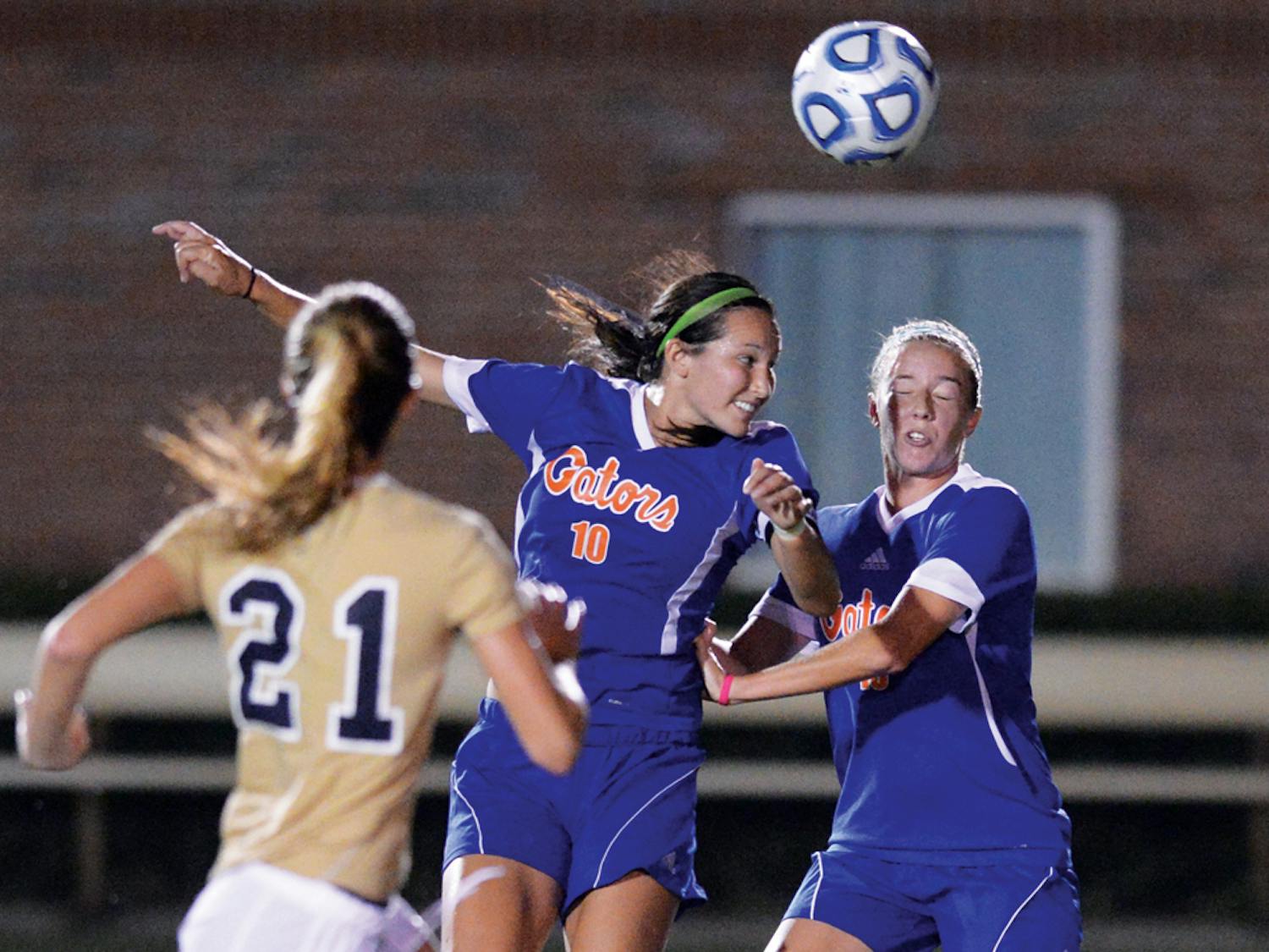 Midfielder Holly King (10) heads a ball during UF's 3-0 victory against Florida International University on Sept. 2. King works as an elementary school teacher at Levy County elementary school every Wednesday.