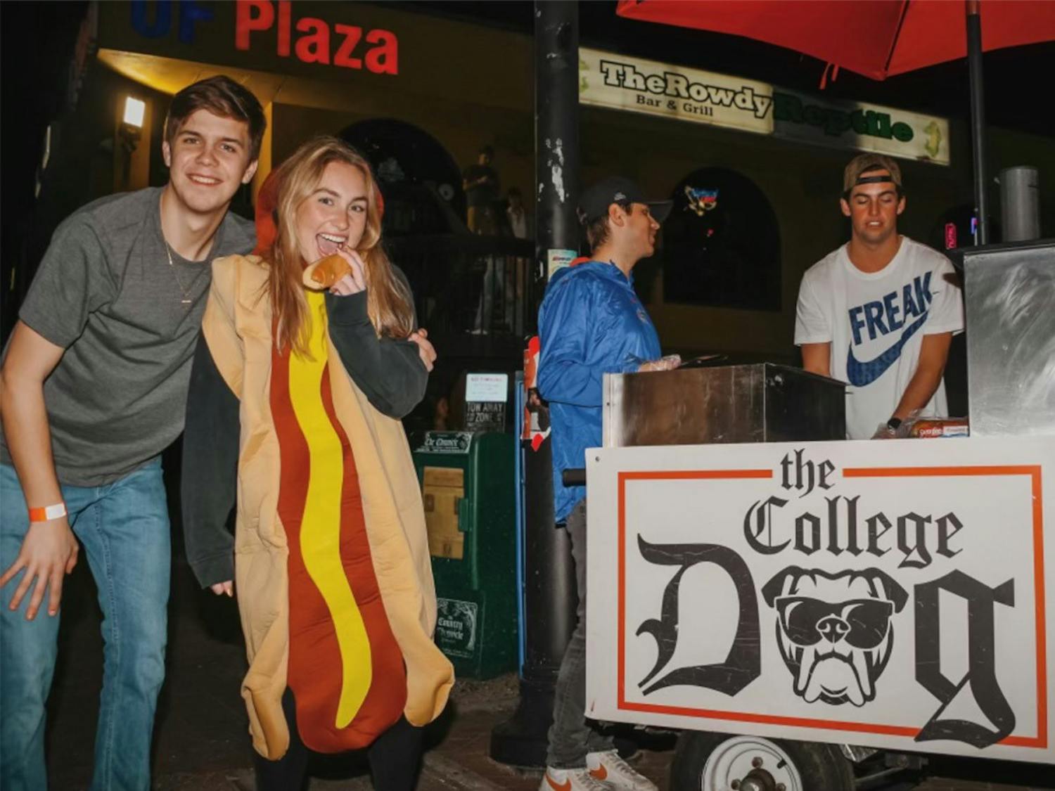 Cole Wilson poses with Olivia Roberts, Owen Shimberg and J. Rex Farrior in front of The College Dog on Saturday, January 21, 2023.