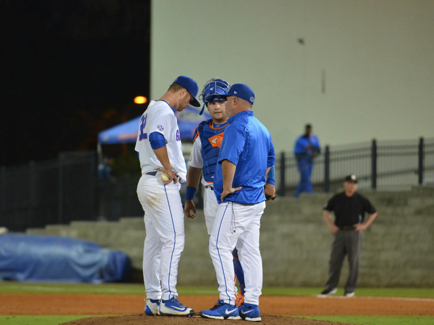 Kevin O'Sullivan and Mike Rivera meet with Logan Shore on the mound during Florida's 4-3 win against Missouri on March 18, 2016, at McKethan Stadium. 