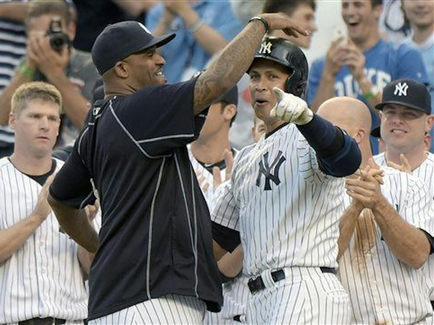 New York Yankees' Alex Rodriguez, center right, celebrates with CC Sabathia after Rodriguez hit a home run — his 3,000th career hit — during the first inning of a baseball game against the Detroit Tigers on June 19 at Yankee Stadium in New York.