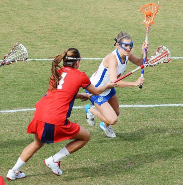 Sophomore midfielder Nora Barry runs past Stony Brook’s Amber Kupres during the Gators’ 16-9 win on Feb. 20 at Dizney Stadium. Barry scored three goals in Florida's 22-1 win against Stetson on Tuesday.