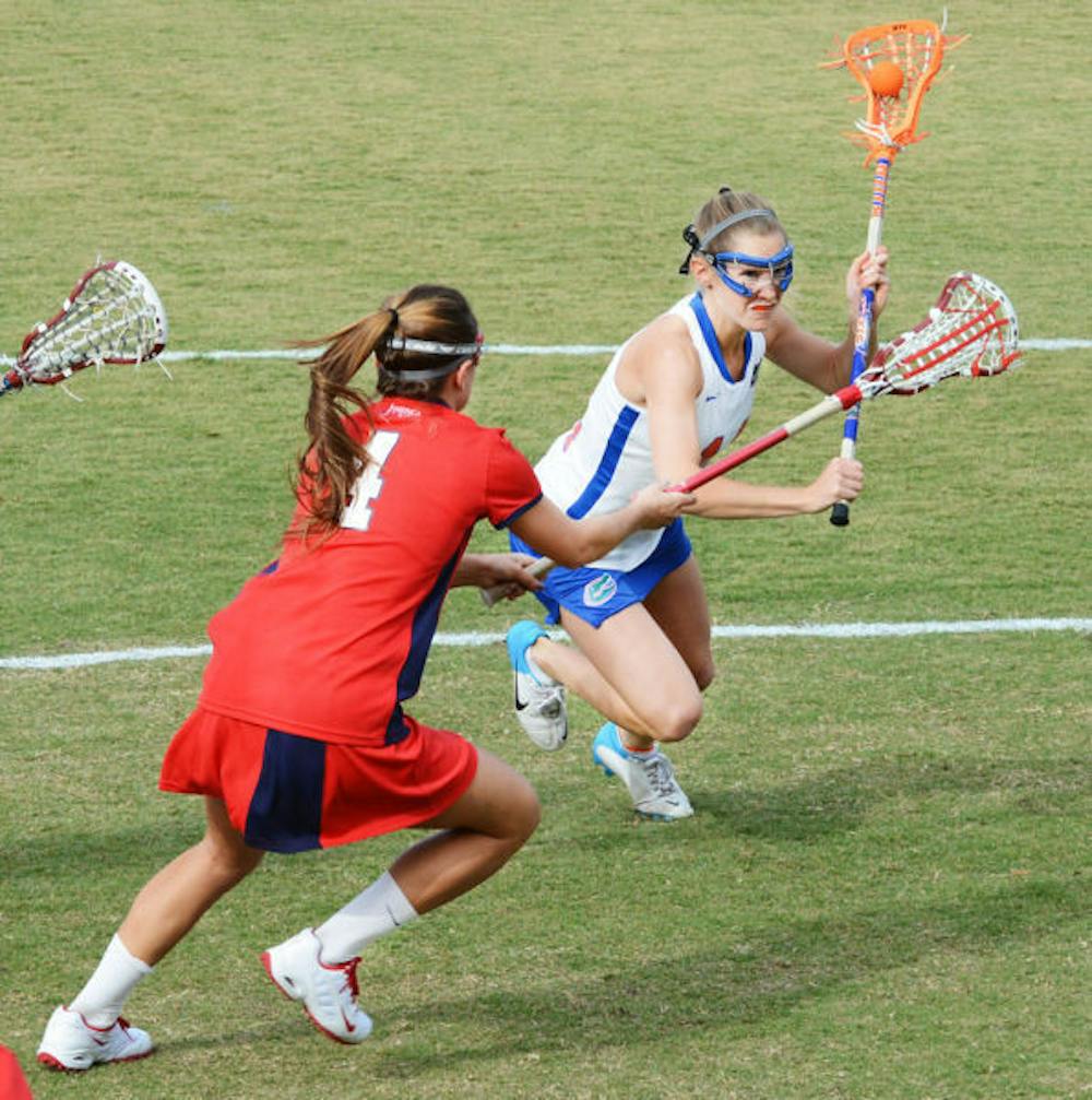 <p align="justify">Sophomore midfielder Nora Barry runs past Stony Brook’s Amber Kupres during the Gators’ 16-9 win on Feb. 20 at Dizney Stadium. Barry scored three goals in Florida's 22-1 win against Stetson on Tuesday.</p>