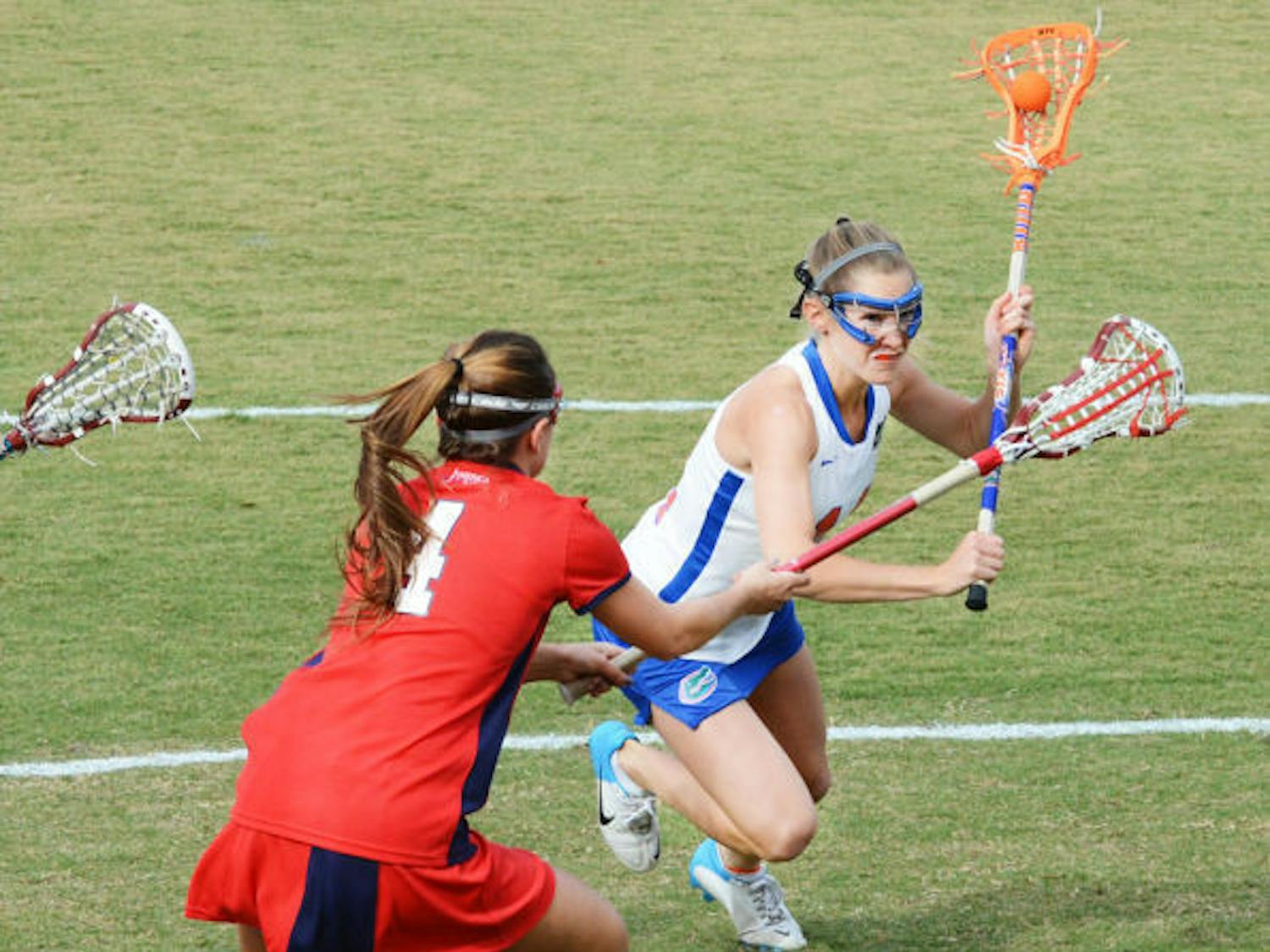 Sophomore midfielder Nora Barry runs past Stony Brook’s Amber Kupres during the Gators’ 16-9 win on Feb. 20 at Dizney Stadium. Barry scored three goals in Florida's 22-1 win against Stetson on Tuesday.