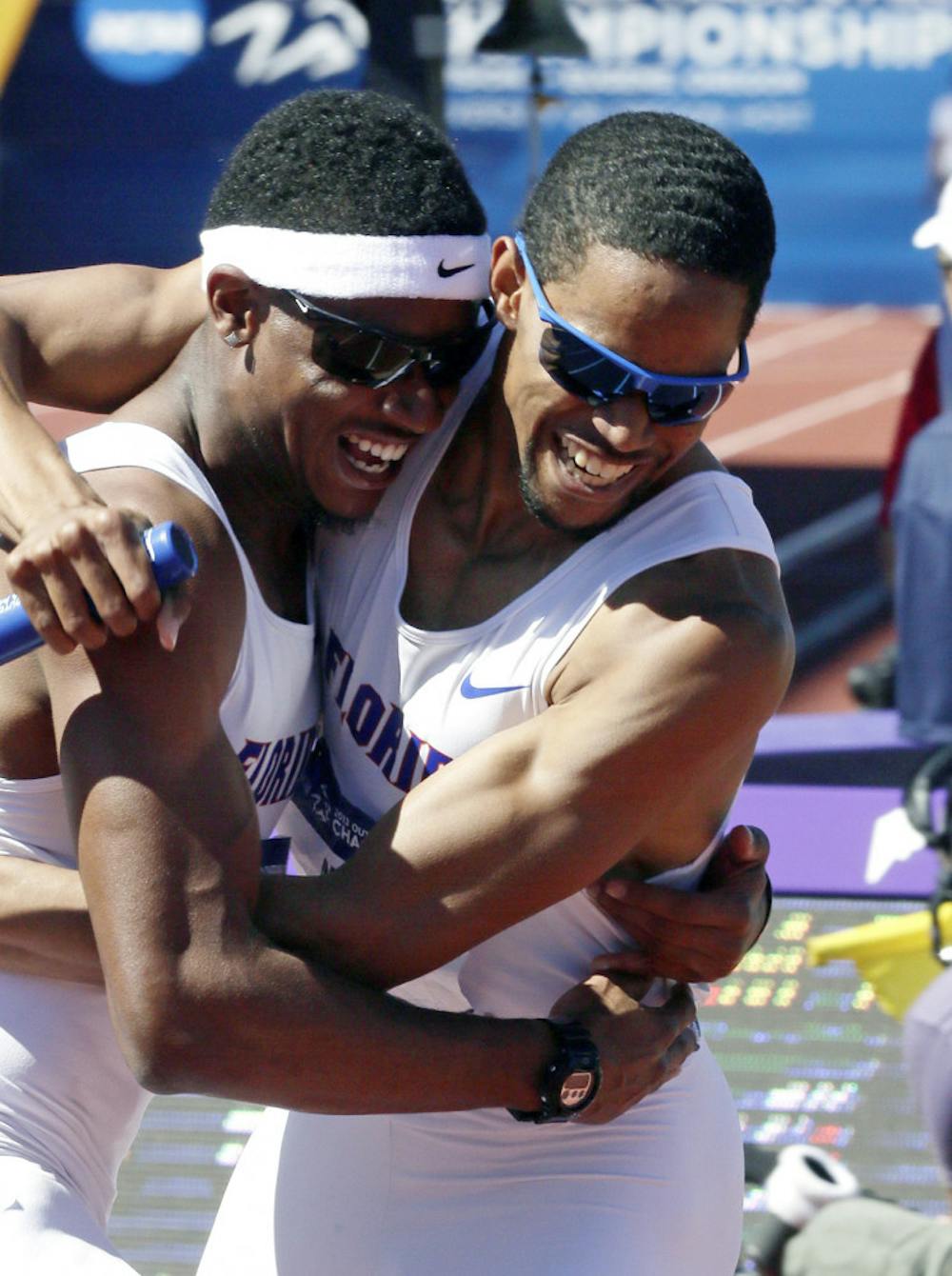 <p>Hugh Graham Jr. (left) hugs Arman Hall after winning the 4x400m relay during the NCAA outdoor championships in Eugene, Ore., on Saturday.</p>