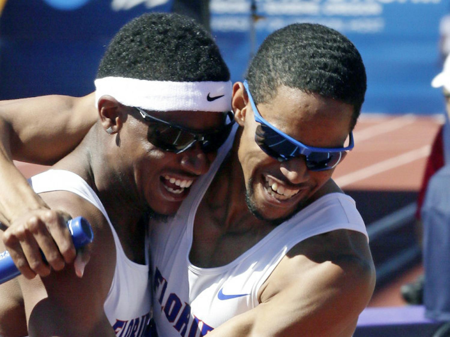 Hugh Graham Jr. (left) hugs Arman Hall after winning the 4x400m relay during the NCAA outdoor championships in Eugene, Ore., on Saturday.